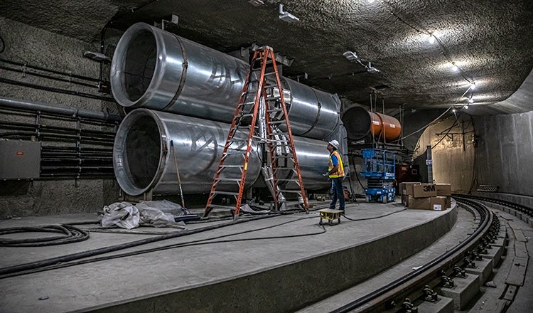 Pipes and construction equipment in rail tunnel