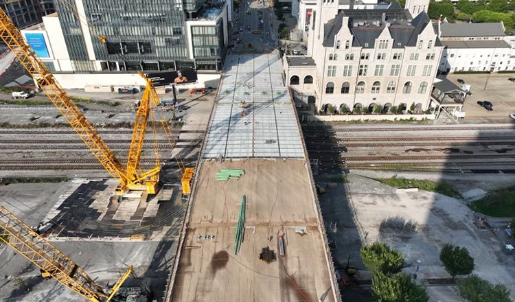 Crane sitting alongside unfinished Broadway Bridge