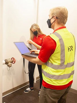 two hdr employees working in a facility