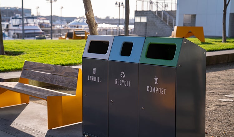 Waste, recycling and compast conatiners in a park